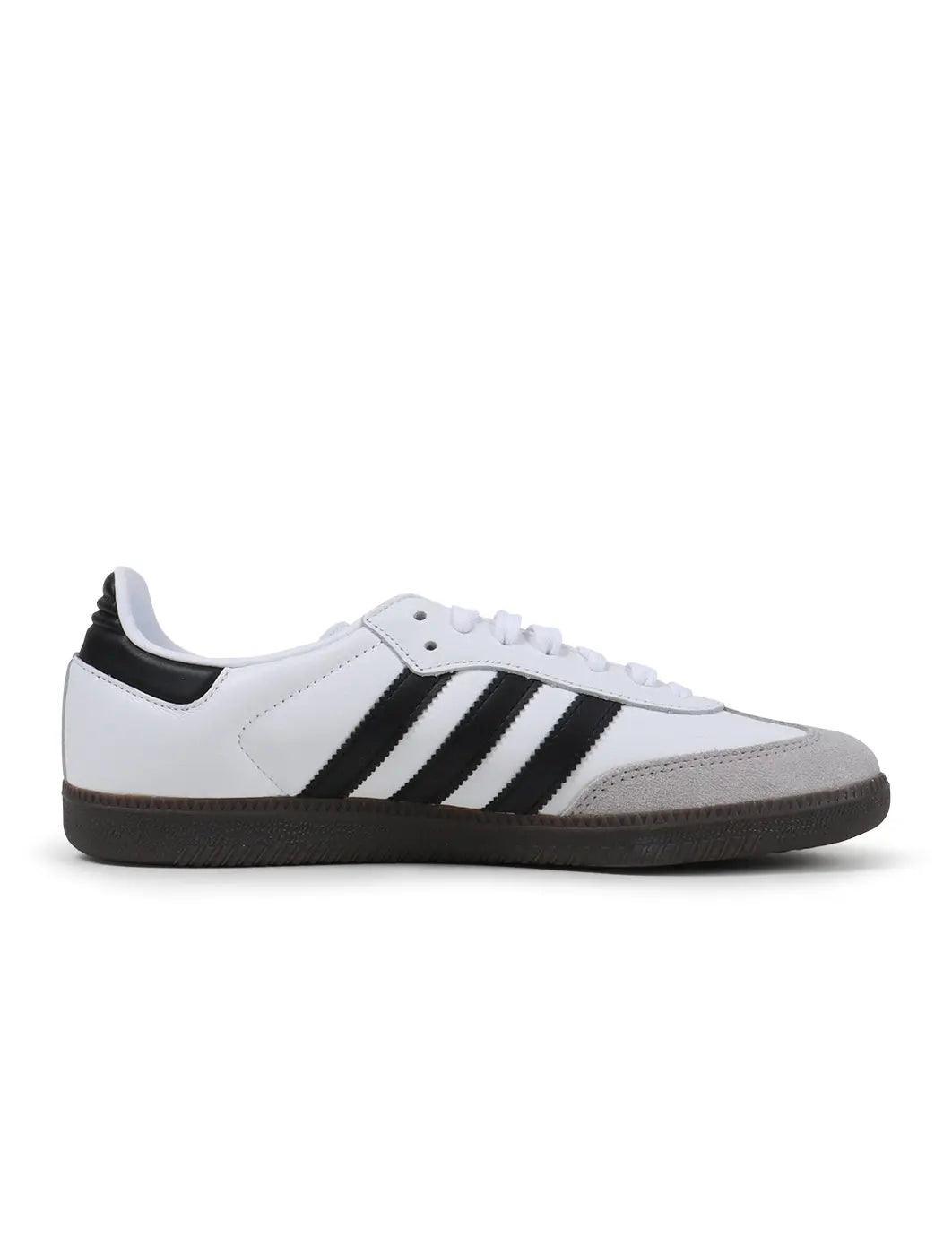 Adidas Samba OG sneaker side view with white upper, black stripes, suede toe, and gum sole.